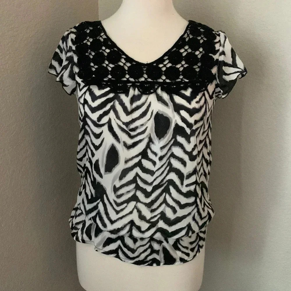 QUINTESSENTIAL black and white zebra patterned top with crochet detail